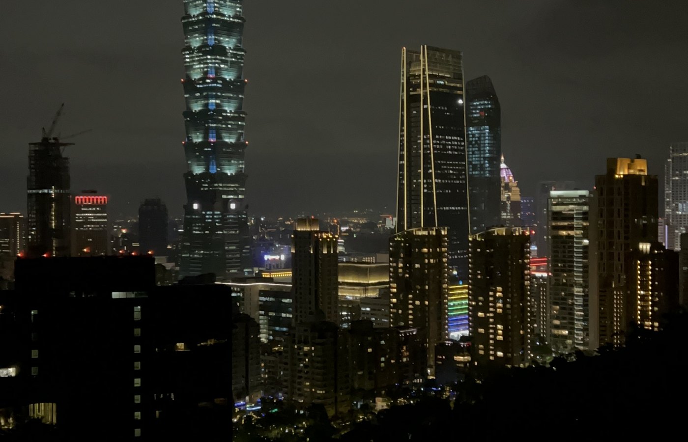 Taipei 101 lit up above the city skyline at night
